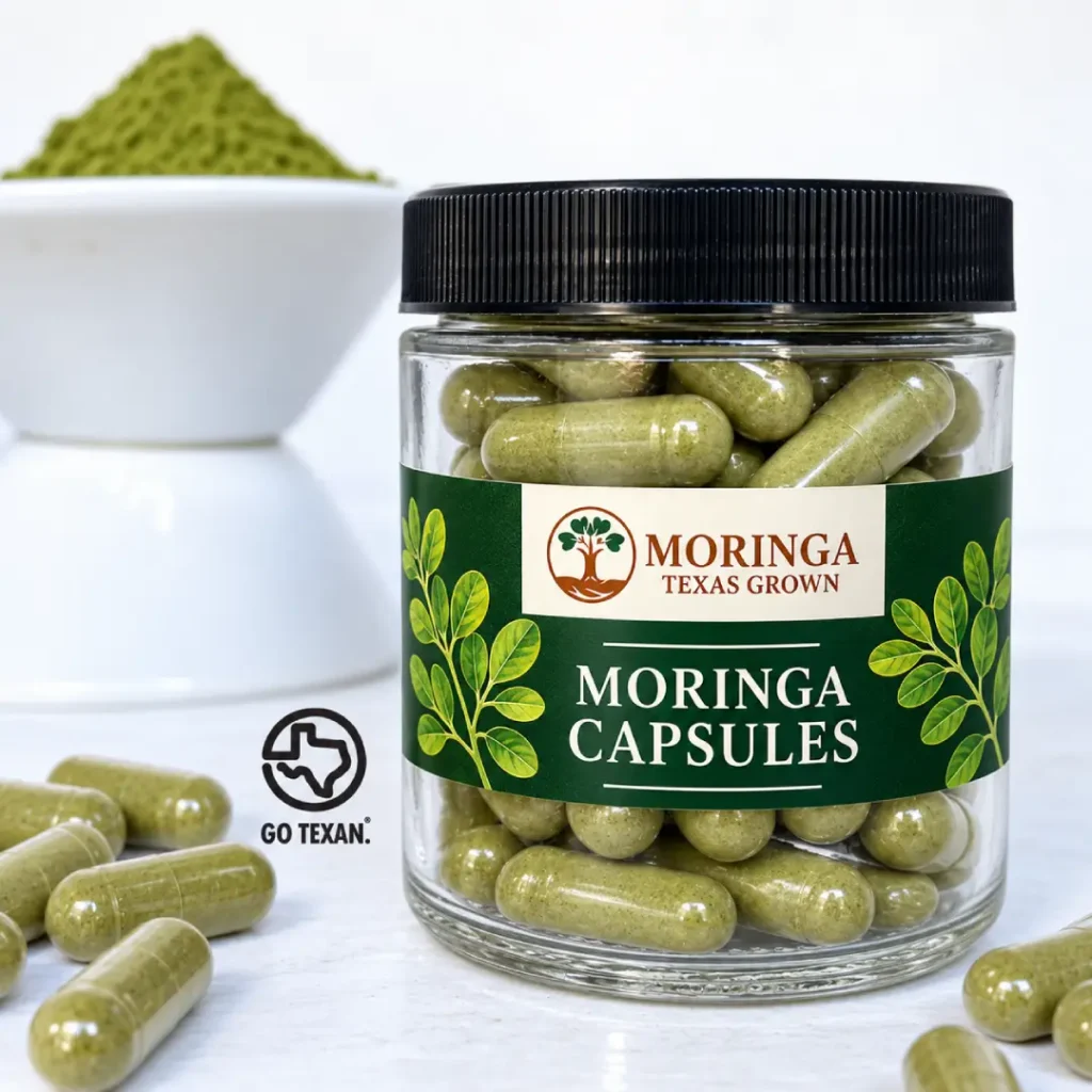 Moringa Texas Grown capsules in a clear glass jar with moringa powder and loose capsules, featuring the GO TEXAN logo.